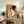 Sophisticated Japanese woodblock-style wall art showcasing a geisha in elegant kimono with mauve and deep teal palette, holding decorative fan in poised stance.