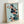 Framed poster of a peaceful bird composition with crimson hibiscus blossoms and foliage in soft greens and creams, showcasing the refined aesthetic of classical Japanese woodblock printmaking.