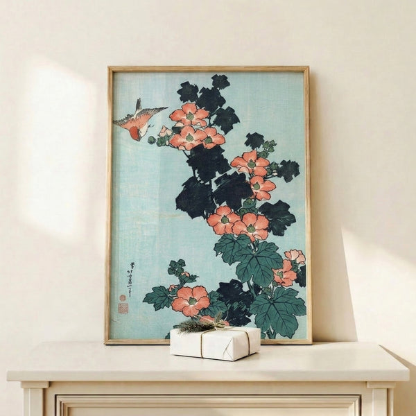 Japanese botanical art print depicting a graceful bird nestled among coral hibiscus flowers and verdant leaves in pale blue-green and cream, bordered by bold black outlines.