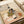 Traditional Japanese-style woodblock artwork portraying domestic intimacy—a woman and child in an interior setting with carefully detailed fabrics and furnishings in warm earth tones.