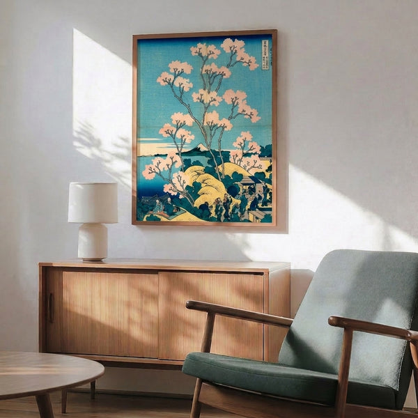 Japandi wall poster featuring a tranquil mountain and cherry blossom scene in traditional woodblock style, palette of prussian blue, pale yellow, cream, and black.