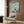 Contemplative Japanese art print with Mount Fuji, cherry blossoms, and architectural elements framed on wall, executed in harmonious cream, teal, and deep blue tones.