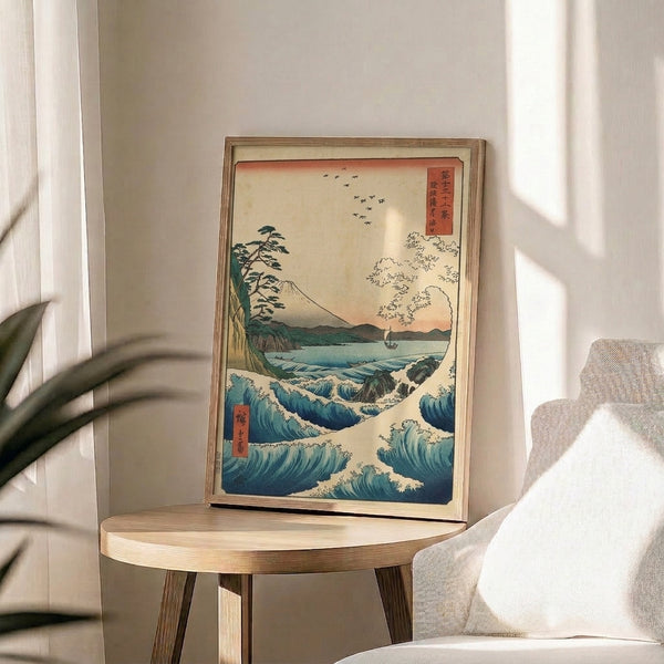 Traditional Japanese landscape artwork showing Mount Fuji towering over rolling ocean waves, boat, and pine trees in contemplative palette of indigo blue and cream.