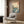 Framed Mount Fuji landscape print in Japanese woodblock tradition, serene yet majestic peak overlooking teal-hued ocean with boat and birds in contemplative mood.