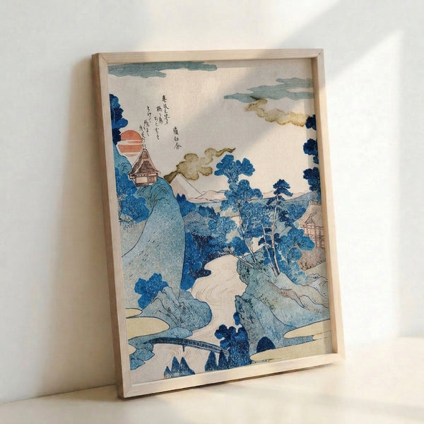 Classic Japanese landscape artwork showing a sunrise over mountains and water, with a delicate pagoda and trees in the composition, using rich blue and rust tones characteristic of traditional prints.