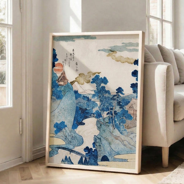 Framed woodblock print presenting an ethereal mountain scene with a temple pavilion, ancient trees, and serene water elements bathed in warm sunrise light and cool blue shadows.