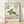 Vintage Japanese woodblock-style poster featuring a leaping hare rendered in cream, tan, and mauve tones, accompanied by elegant dark green calligraphy, framed on a wall.
