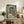 Japanese ukiyo-e print on wall featuring a warrior in ceremonial armor, rendered with striking contrast between deep indigo waves and cream highlights in classic woodblock aesthetic.