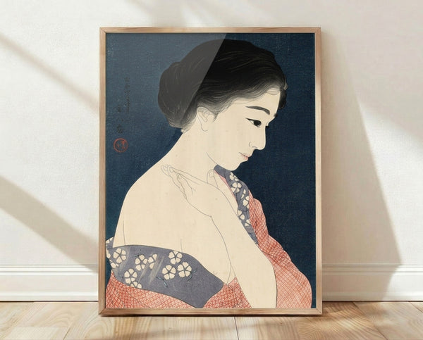 Framed vintage Japanese woodblock print depicting a serene woman in an ornate kimono with deep teal and red-coral tones, her face obscured in contemplative elegance.