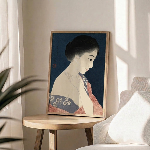 Contemplative vintage Japanese woodblock print mounted as framed wall art, depicting a woman in traditional dress with deep teal, coral, and cream textile patterns.