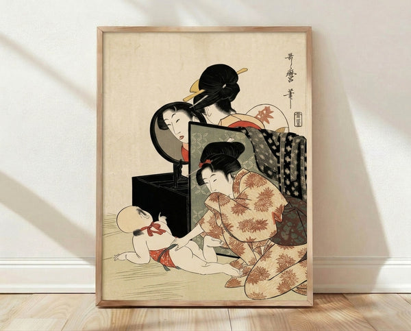 Japanese woodblock art print depicting a woman and child gazing into a mirror, rendered in warm cream, rust red, and sage green tones with delicate black line work, framed on a wall.