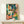 Energetic retro-modern artwork featuring a musician with trumpet and palm trees in bold turquoise, orange, and dark green colors, printed as a framed poster.