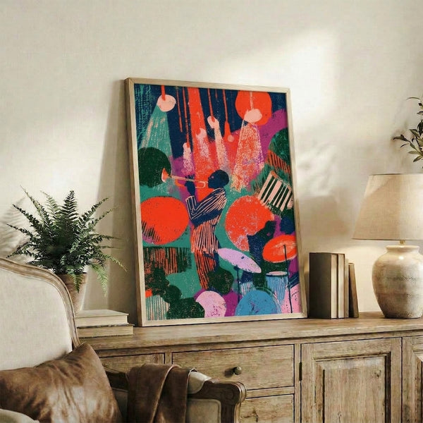 Modern pop art print on wall showing a dynamic musician playing trumpet amid celebratory geometric forms in bright jewel tones and warm orange hues.
