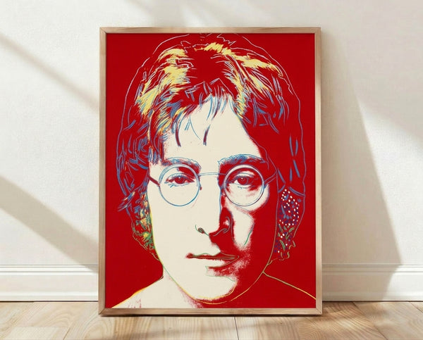 Pop art portrait of John Lennon in vibrant colors, rendered in Andy Warhol's iconic silkscreen style with bold graphic shapes and contrasting hues.