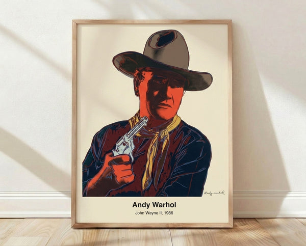 Pop art portrait of John Wayne in bold orange, yellow, and black tones, framed poster with Warhol's iconic style and ironic cowboy imagery.