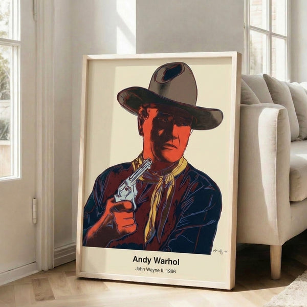 Andy Warhol-inspired portrait print of John Wayne in vivid yellows and oranges with graphic black accents, modern pop art aesthetic.