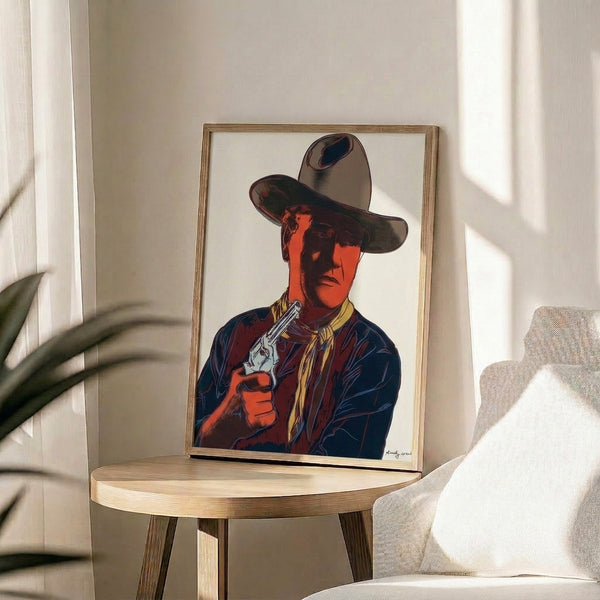 Vibrant framed print of John Wayne rendered in Warhol's signature pop art palette with saturated colors and simplified forms.