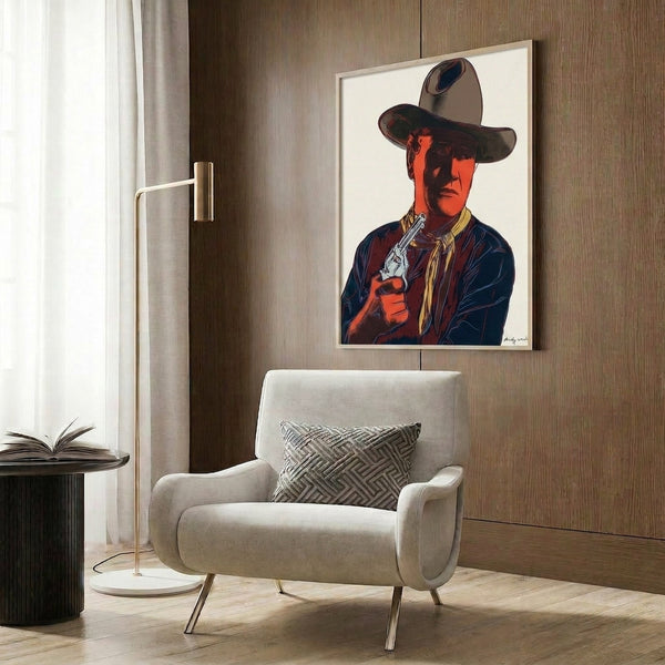 John Wayne portrait in electric pop art colors with high-contrast graphic treatment and distinctive silkscreen quality, framed on wall.