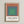 Framed abstract art print with concentric color fields in warm and cool tones—terracotta, sage, and blue—evoking calm geometric harmony.