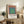 Abstract Bauhaus print of centered squares in harmonious earth and cool tones—terracotta, cream, sage green, and slate blue.
