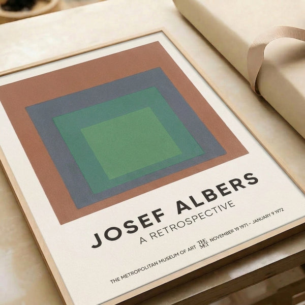 Contemplative minimalist artwork presenting concentric square forms in muted terracotta, sage, light green, and blue hues.