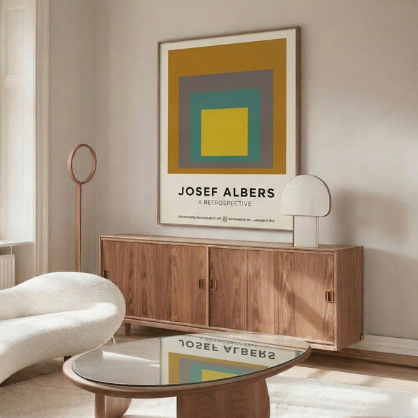 Contemplative color field artwork showing concentric squares in warm ochre, soft gray, and cool teal arranged in balanced geometric progression.