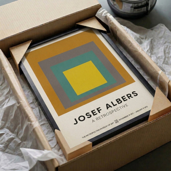 Framed minimalist poster featuring stacked squares in gold, gray, and teal creating a meditative geometric composition in Bauhaus style.