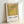 Mid-century modern framed artwork with four nested squares in harmonious gold and green hues, exemplifying Bauhaus color theory.