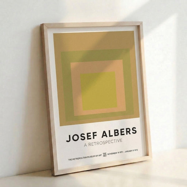 Mid-century modern framed artwork with four nested squares in harmonious gold and green hues, exemplifying Bauhaus color theory.
