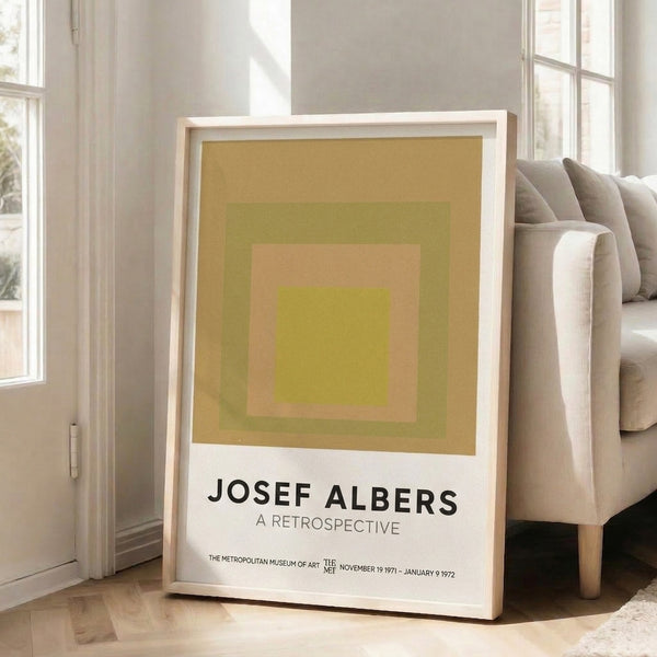 Meditative composition of square forms in warm metallics and muted greens, a classic Bauhaus color harmony study framed for display.