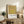 Framed minimalist poster with stacked squares in gold, yellow-green, and peachy tones exploring geometric color relationships.