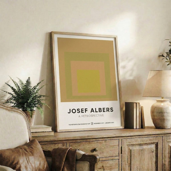 Framed minimalist poster with stacked squares in gold, yellow-green, and peachy tones exploring geometric color relationships.