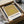 Museum-quality print of nested colored squares in olive, chartreuse, and warm peachy-gold, mounted as framed modern wall art.