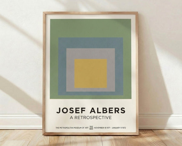Framed geometric poster featuring concentric squares in sage green, slate blue, and warm gray tones, exemplifying Bauhaus minimalist design with a serene, meditative quality.