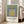 Abstract geometric print with concentric squares in golden yellow, slate blue, and sage green, exemplifying the meditative color harmony of Bauhaus minimalism.
