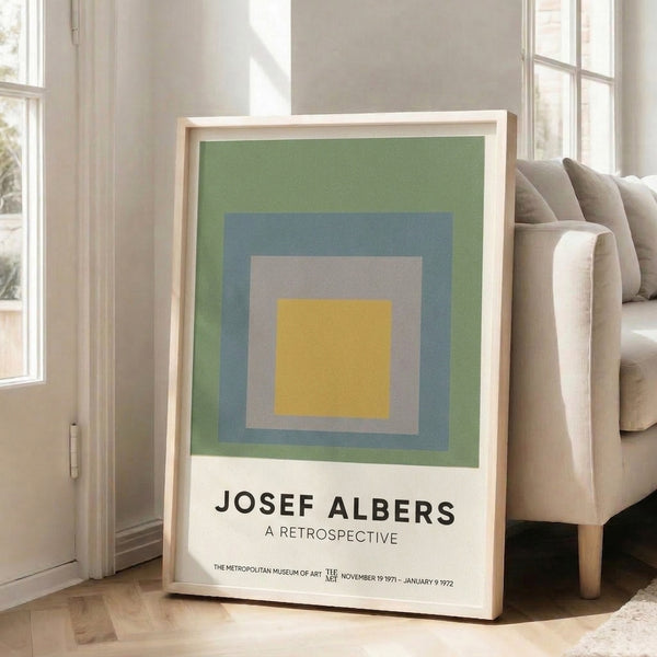 Abstract geometric print with concentric squares in golden yellow, slate blue, and sage green, exemplifying the meditative color harmony of Bauhaus minimalism.