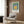 Minimalist Bauhaus-style poster featuring nested geometric squares in a soothing palette of sage green, golden yellow, and soft blue hues.
