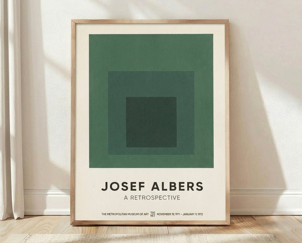 Minimalist geometric poster featuring concentric squares in sage green, forest green, charcoal, and cream tones, embodying Bauhaus design principles and meditative color harmony.