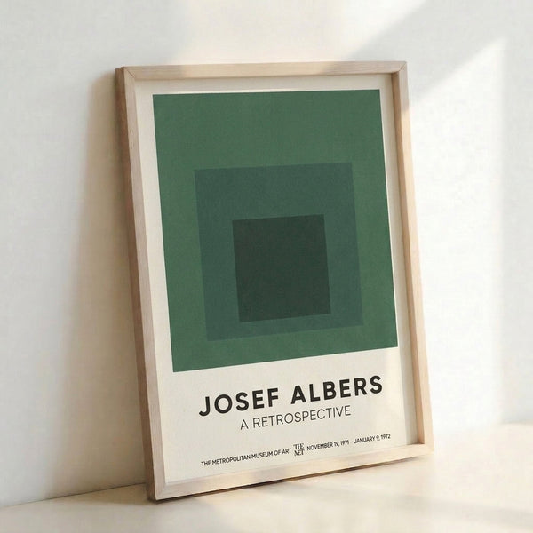 Modern minimalist poster showcasing layered squares in soft sage green and charcoal, a meditative composition rooted in Bauhaus color theory.