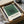 Framed print featuring overlapping squares in sage green, forest green, cream, and charcoal tones—a contemplative study in Bauhaus minimalism and color relationships.