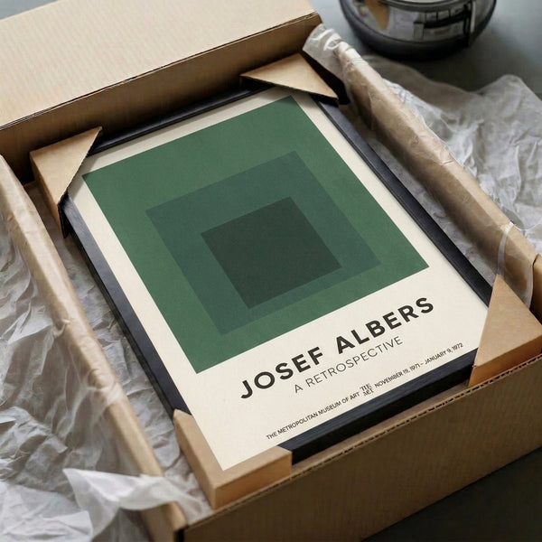 Framed print featuring overlapping squares in sage green, forest green, cream, and charcoal tones—a contemplative study in Bauhaus minimalism and color relationships.