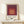 Minimalist wall art print composed of nested rectangular forms in warm red and peachy tones, embodying Bauhaus principles of form and color harmony.