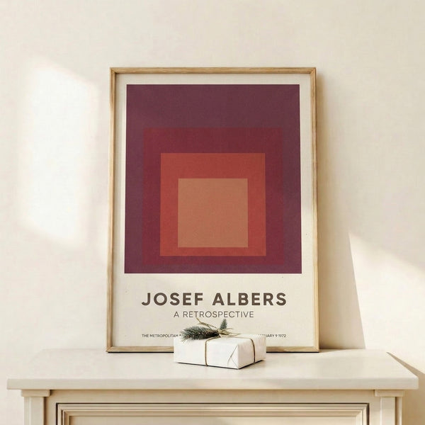 Minimalist wall art print composed of nested rectangular forms in warm red and peachy tones, embodying Bauhaus principles of form and color harmony.
