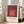 Contemporary framed poster with interlocking squares in cream, coral, and deep maroon, evoking a calm, meditative response through precise geometric arrangement.