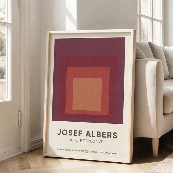 Contemporary framed poster with interlocking squares in cream, coral, and deep maroon, evoking a calm, meditative response through precise geometric arrangement.