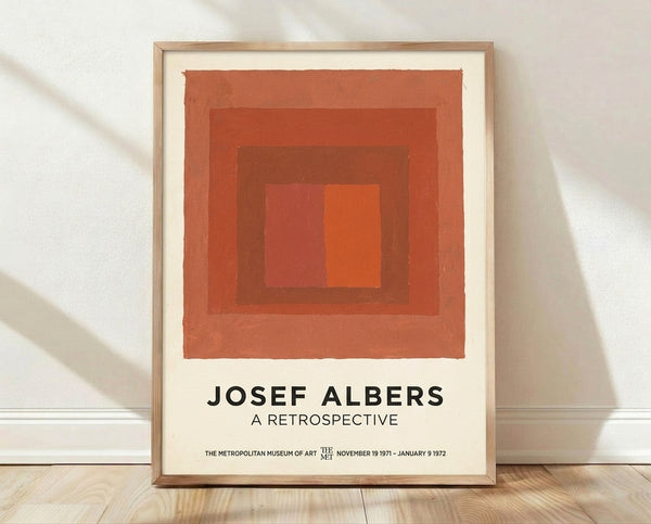 Abstract minimalist framed poster featuring nested squares in rust orange, terracotta, and cream tones, creating a meditative geometric composition.