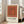 Framed contemporary art print of nested rectangular forms in warm orange and cream palette, embodying midcentury geometric minimalism.
