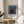 Abstract composition of nested squares rendered in subdued palette of slate blue, charcoal, and cream, exemplifying mid-century Bauhaus design.
