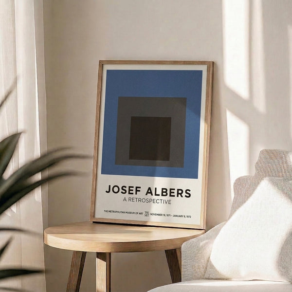 Abstract composition of nested squares rendered in subdued palette of slate blue, charcoal, and cream, exemplifying mid-century Bauhaus design.
