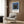 Geometric wall art poster with overlapping rectangular forms in dark brown, charcoal gray, and muted blue, offering refined minimalist appeal.